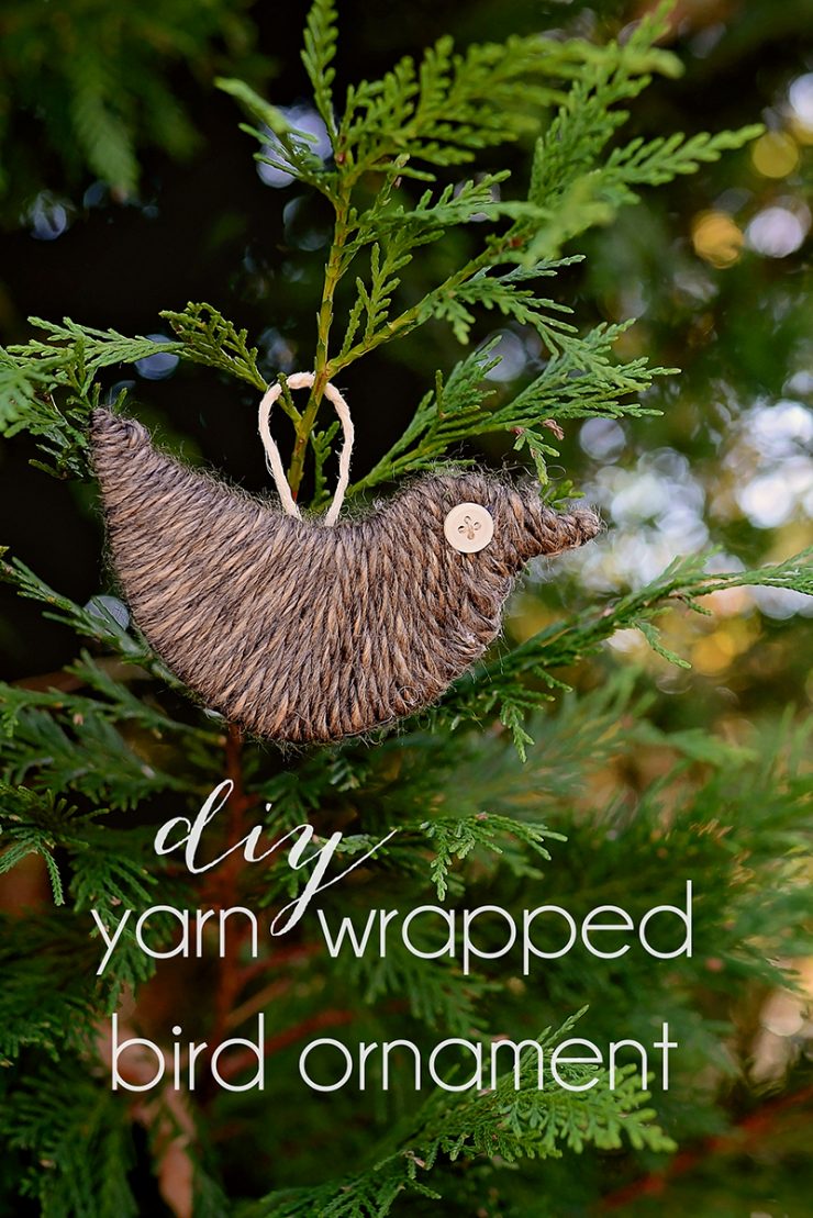 Image shows a yarn wrapped bird on a Christmas tree